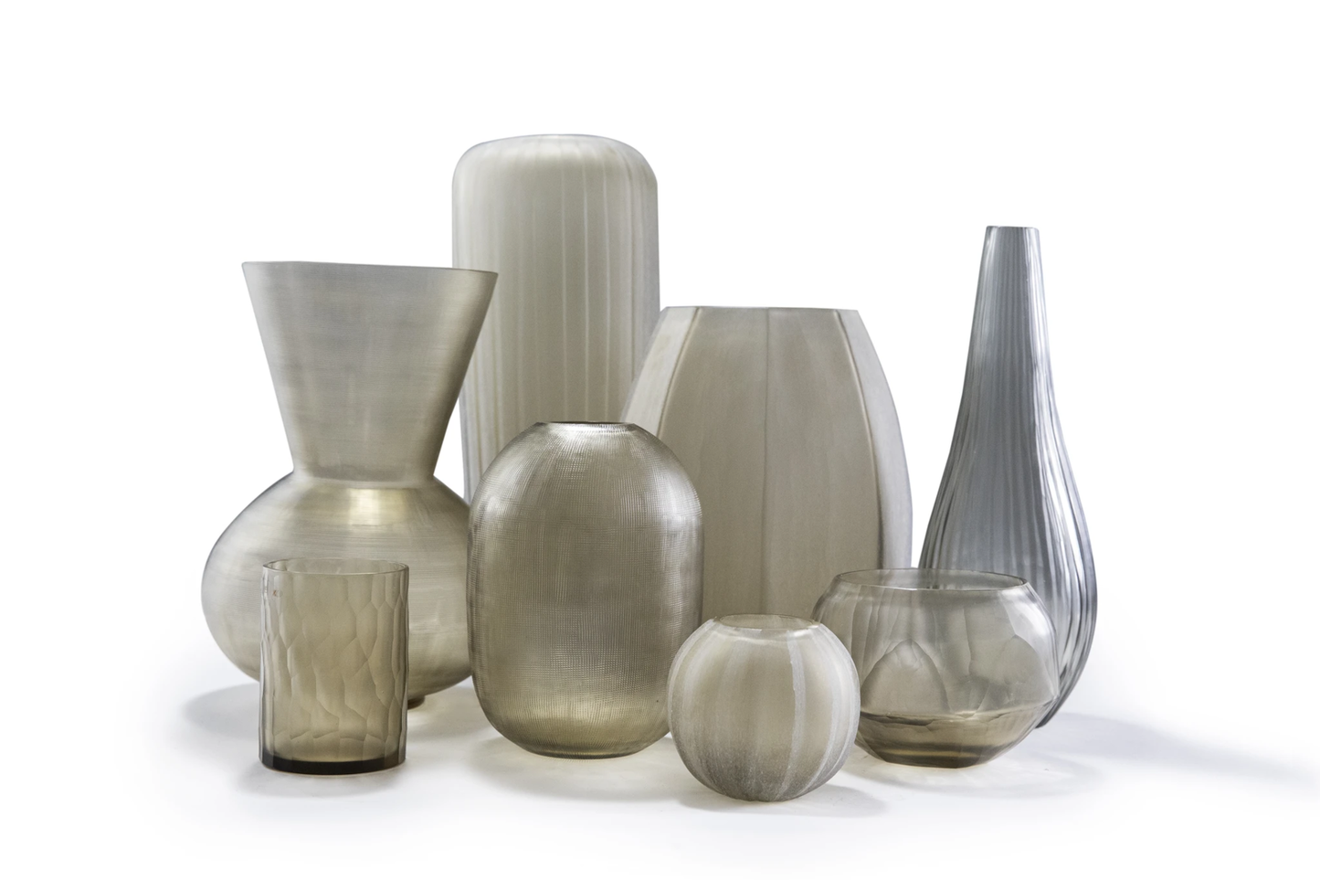 Lowlands Design glass candleholder set featuring various shapes and translucent smoky colours