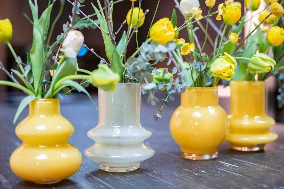 Lowlands Design decorative vase set with colourful yellow and white flowers on wooden table
