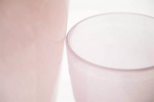 Close-up of pink frosted glass flower vase by Lowlands Design with smooth curved edges