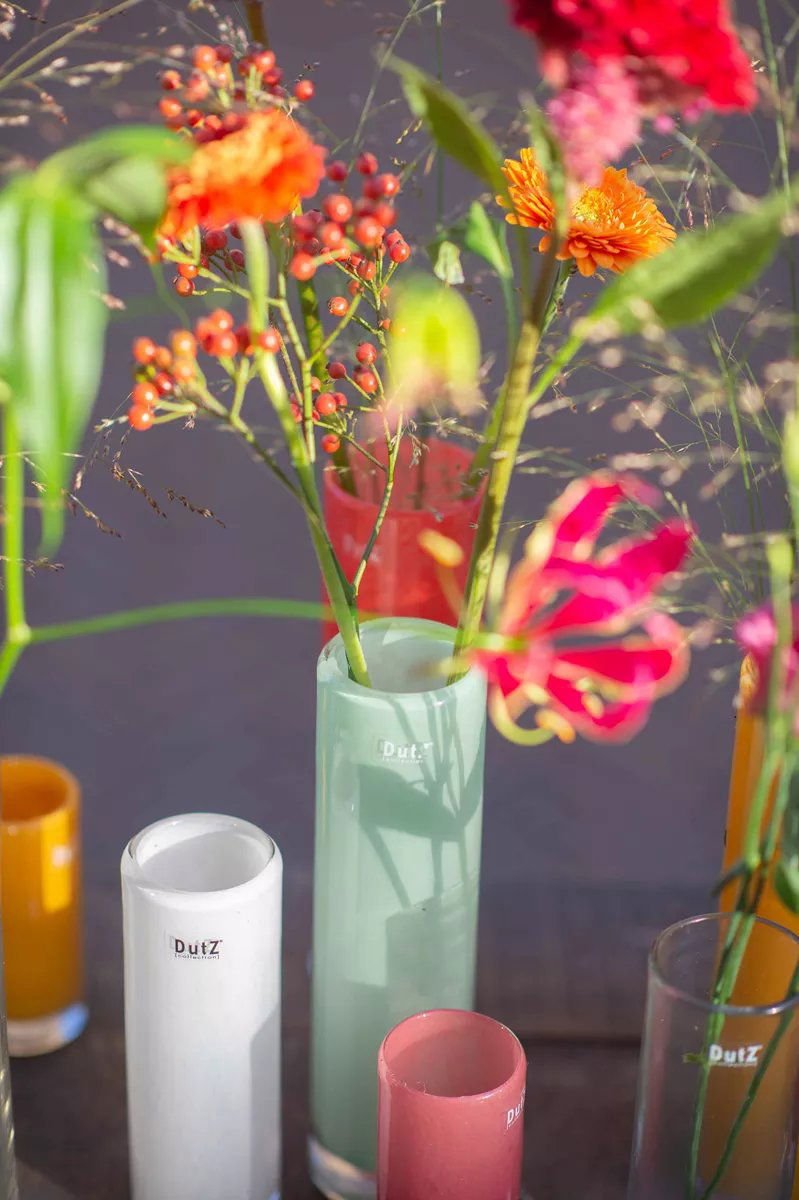 Lowlands Design cylinder vase collection with colourful flower arrangements on a table