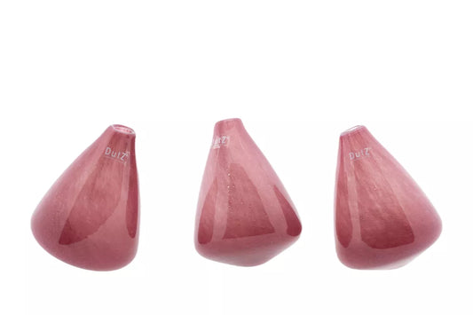 Lowlands Design tumbling vase in pink glass shown in three tilted positions on white background