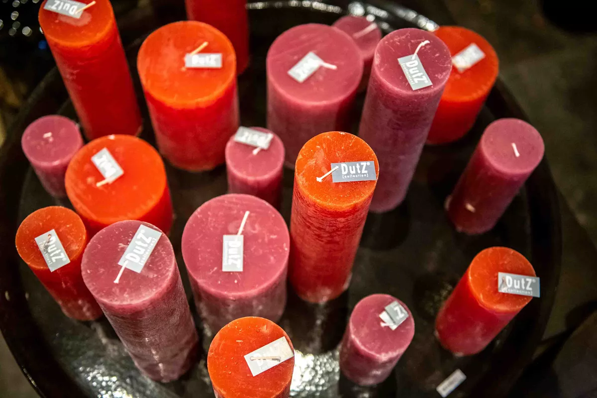 Lowlands Design candles assortment of red and orange pillar candles with Dutz labels on black tray