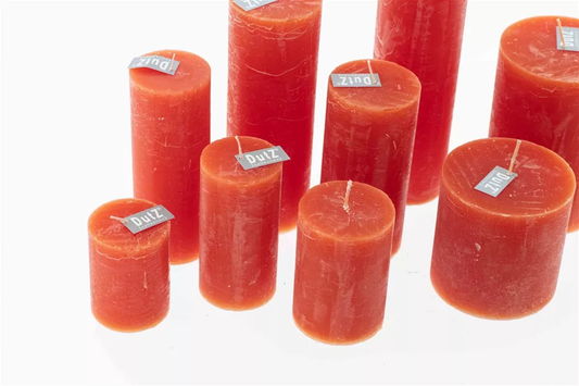 Lowlands Design red pillar candles in assorted sizes with rustic finish on white background