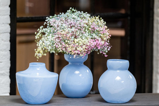 Lowlands Design baby blue glass vase trio on windowsill with central vase of pastel gypsophila arrangement