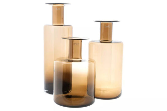 Set of three Lowlands Design amber glass bottle vase pieces in varying heights and shapes