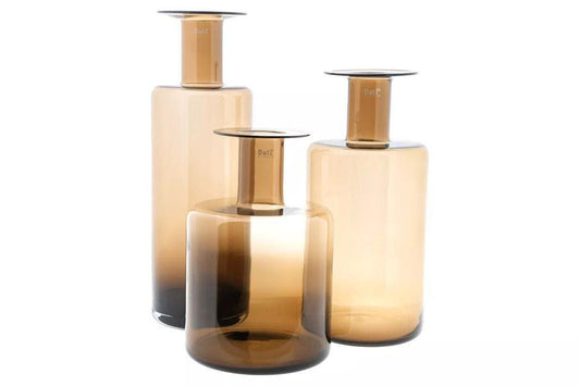 Set of three Lowlands Design amber glass bottle vase pieces in varying heights and shapes