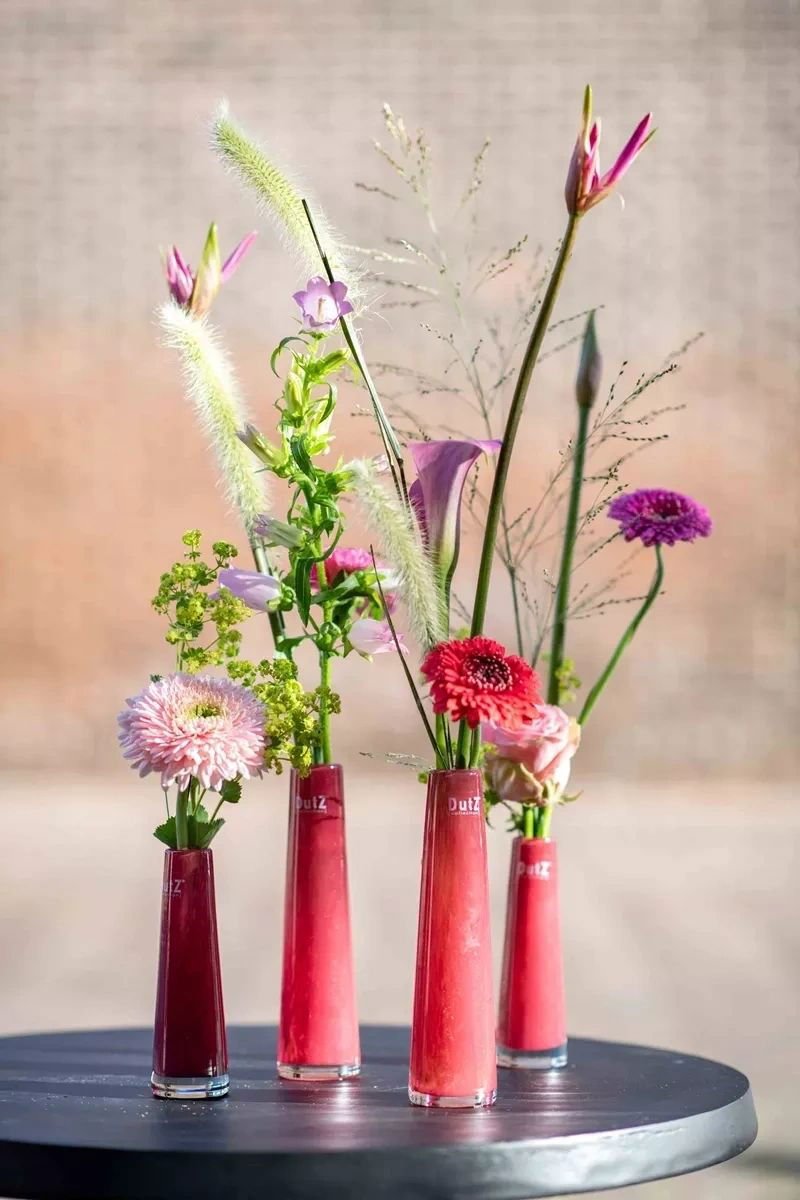 Lowlands Design red solifleur budvase set with assorted fresh flowers on round table
