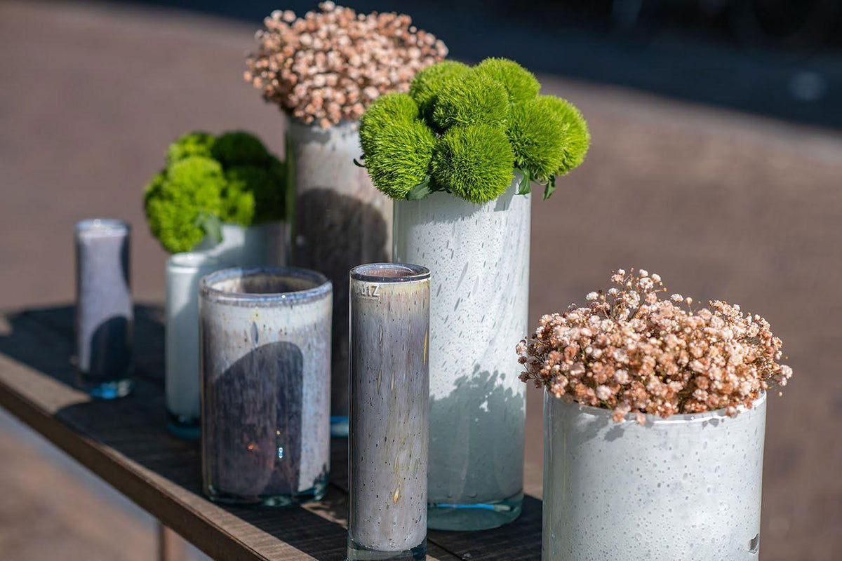 Lowlands Design cylinder vase set with modern white and gray textures holding green and white flowers