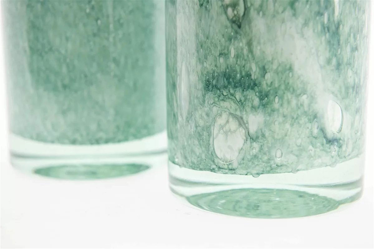 Close-up of green textured cylinder vase by Lowlands Design with artistic glass details