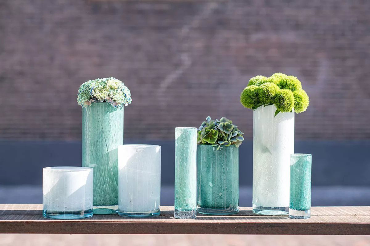 Lowlands Design cylinder vase collection in varying sizes with green and white floral arrangements
