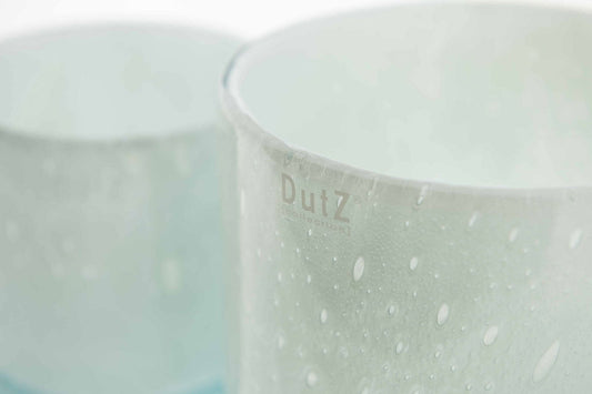 Close-up of a cylinder vase from Lowlands Design with water droplets on the surface