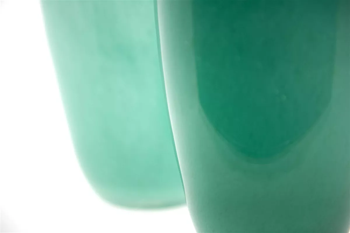 Close-up of green ceramic flowervase by Lowlands Design with smooth glossy finish