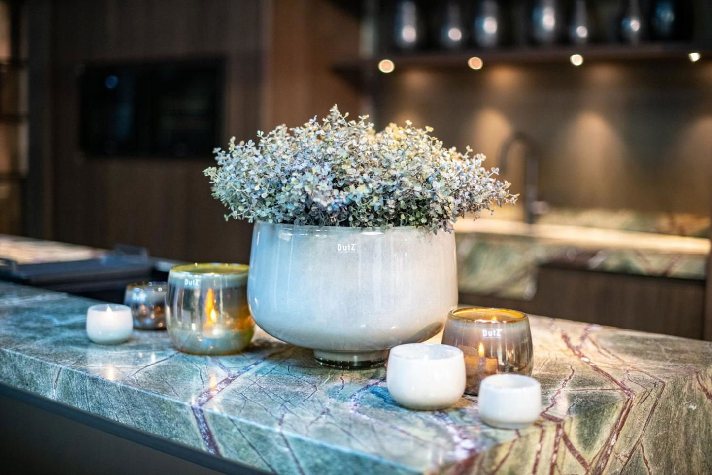 Lowlands Design glass bowl used as a decorative vase with dried flowers on a marble countertop