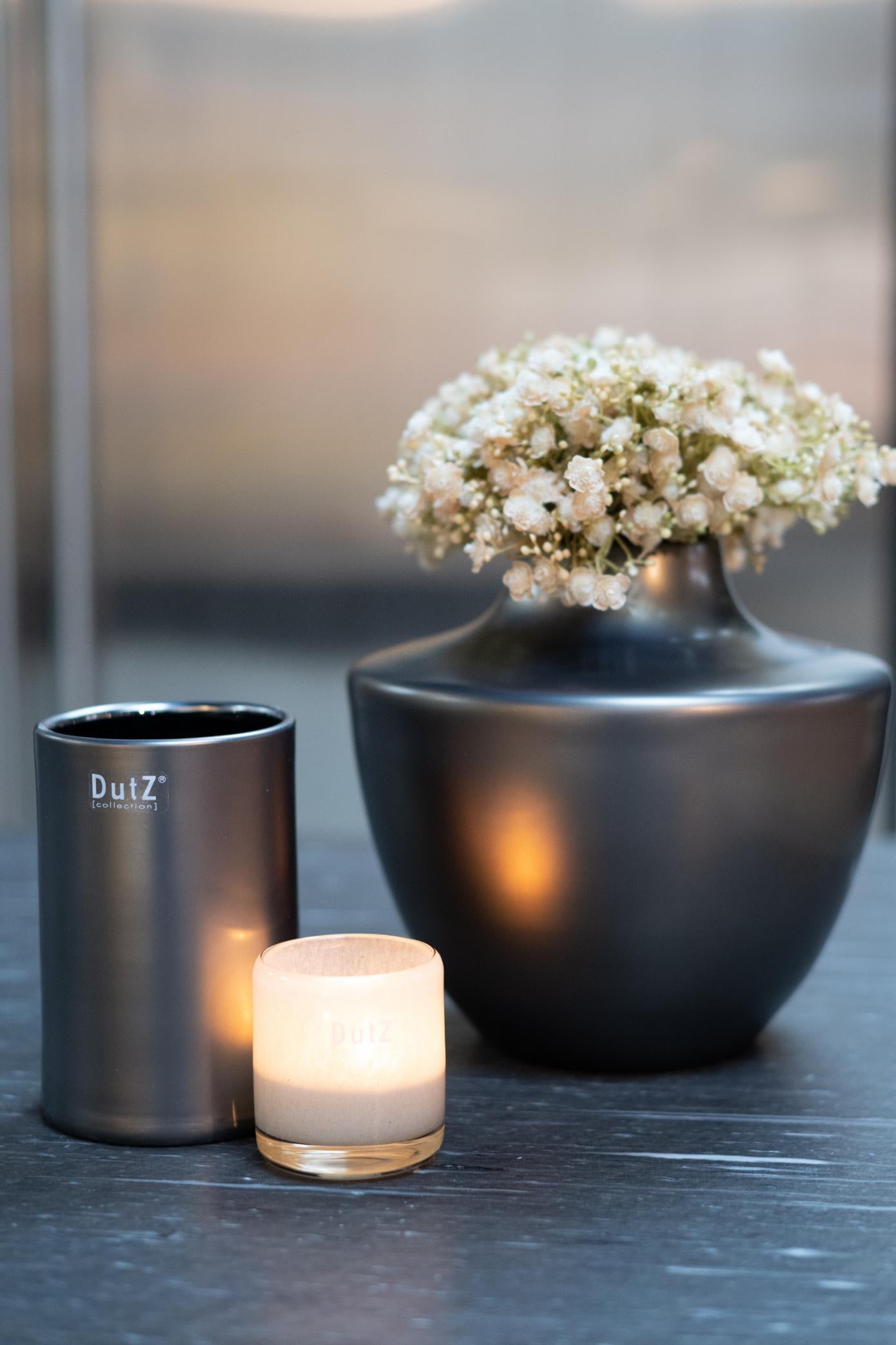 Stylish Lowlands Design vase in black featuring glass mouthblown dutz, paired with candle holders