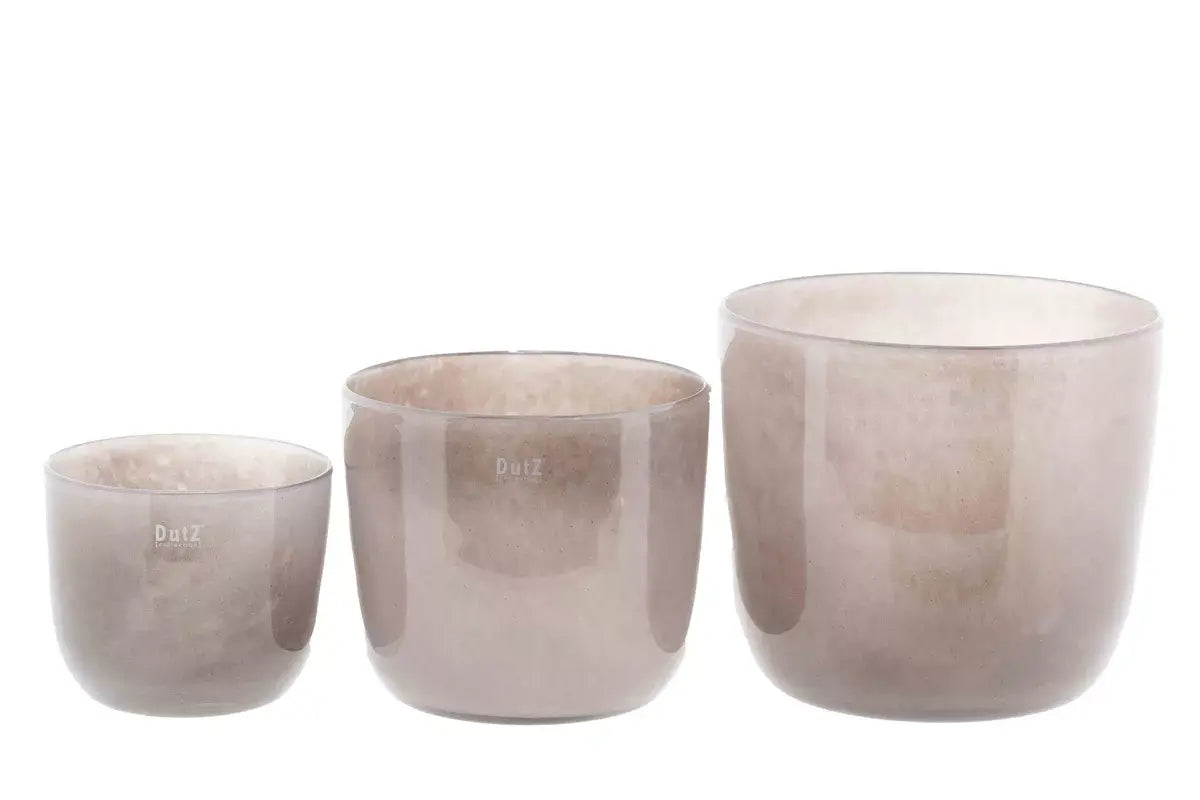 Set of three Lowlands Design glass purple plant pots in varying sizes for stylish indoor plants