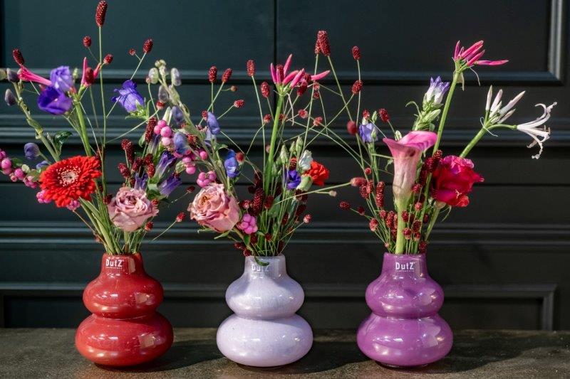 Lowlands Design handmade dutz vase trio in red and lilac with mixed flowers on dark table