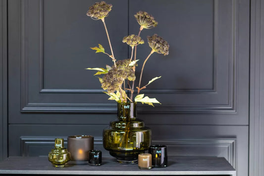 Lowlands Design green glass design vase with tall dried stems and candles luxury decorative vase for living room