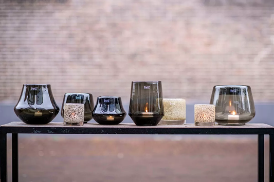 Lowlands Design dark glass orchid pot collection with various sizes on a black metal stand