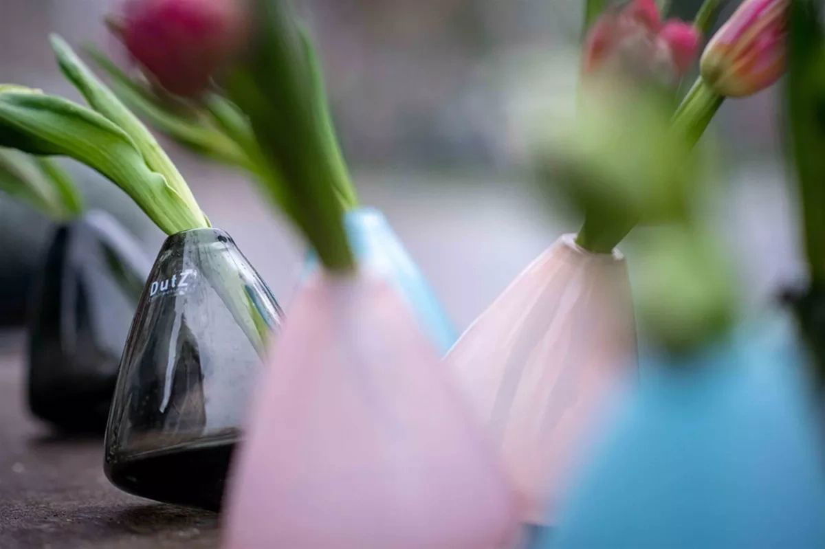 Lowlands Design tumbling vase collection in black, pink, and blue with fresh flowers