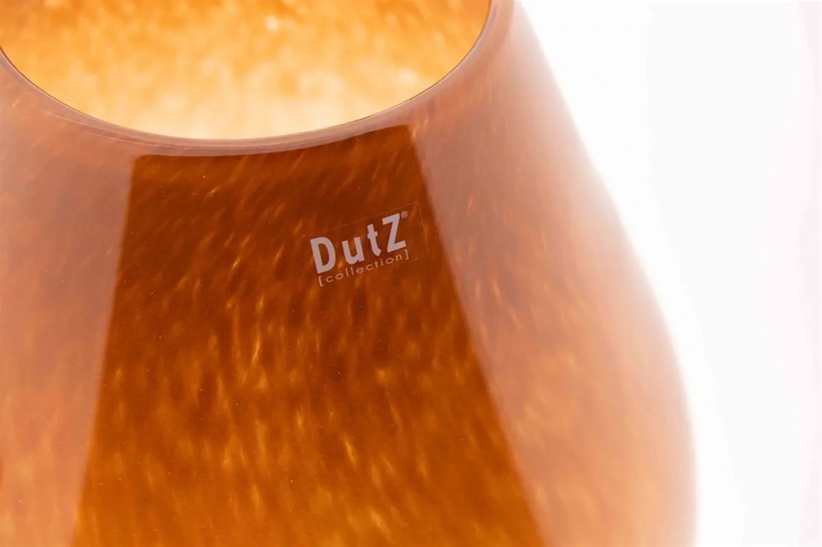 Close-up of Lowlands Design amber glass vase with smooth curved surface and subtle light reflections