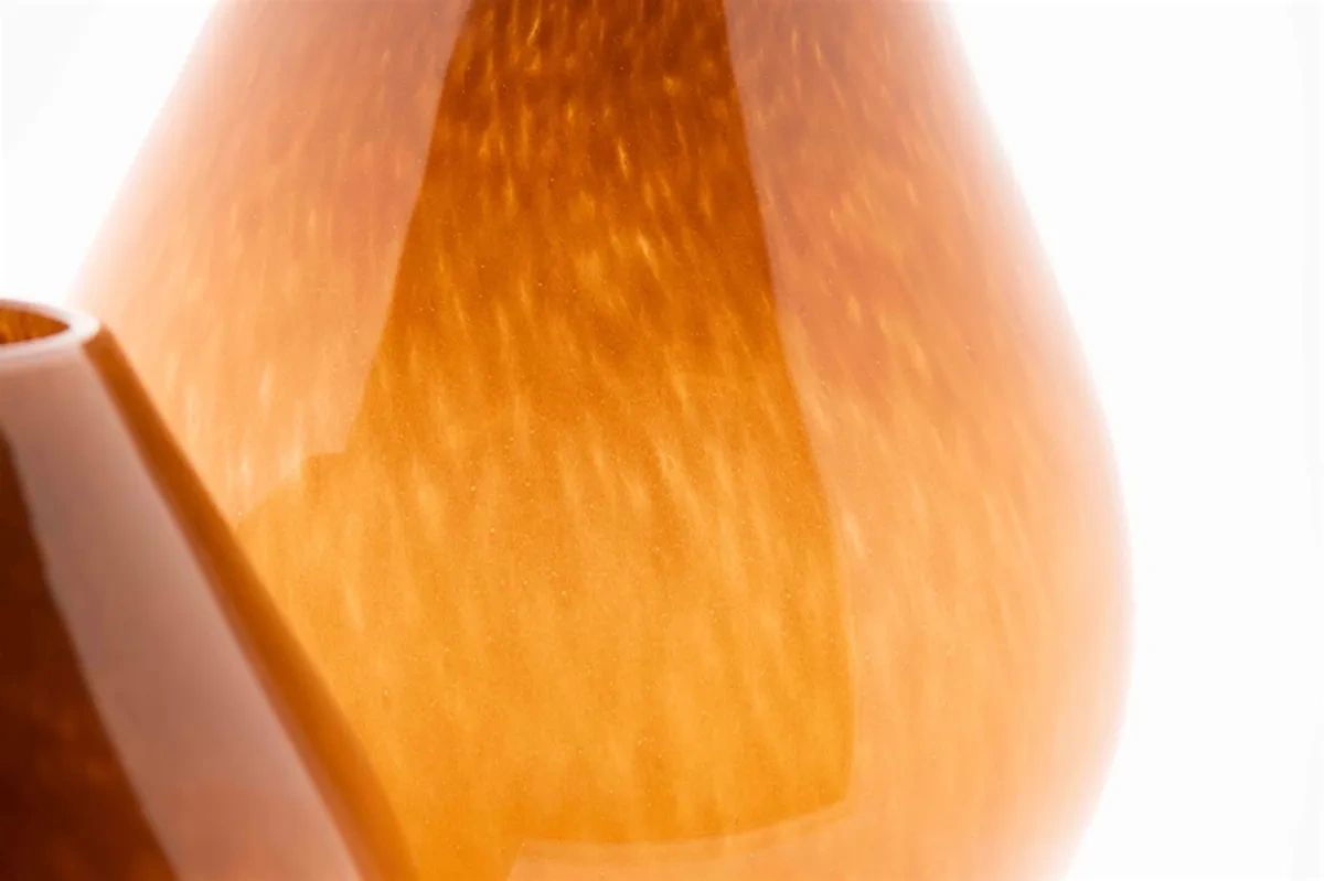 Close-up of Lowlands Design amber glass vase showcasing its smooth texture and elegant shape