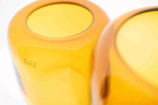 Close-up of yellow glass vase by Lowlands Design showcasing smooth curved surface and premium craftsmanship