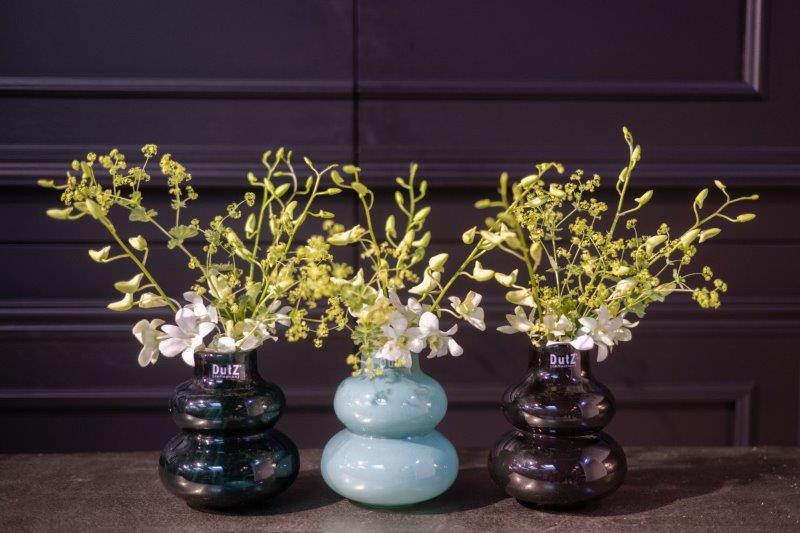 Lowlands Design decorative vase set with unique rounded shapes holding delicate yellow and white flowers