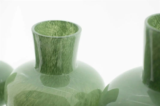 Close-up of green glass vase by Lowlands Design with smooth glossy finish