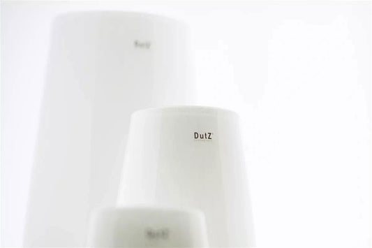 Minimalist white ceramic vase by Lowlands Design with smooth matte finish