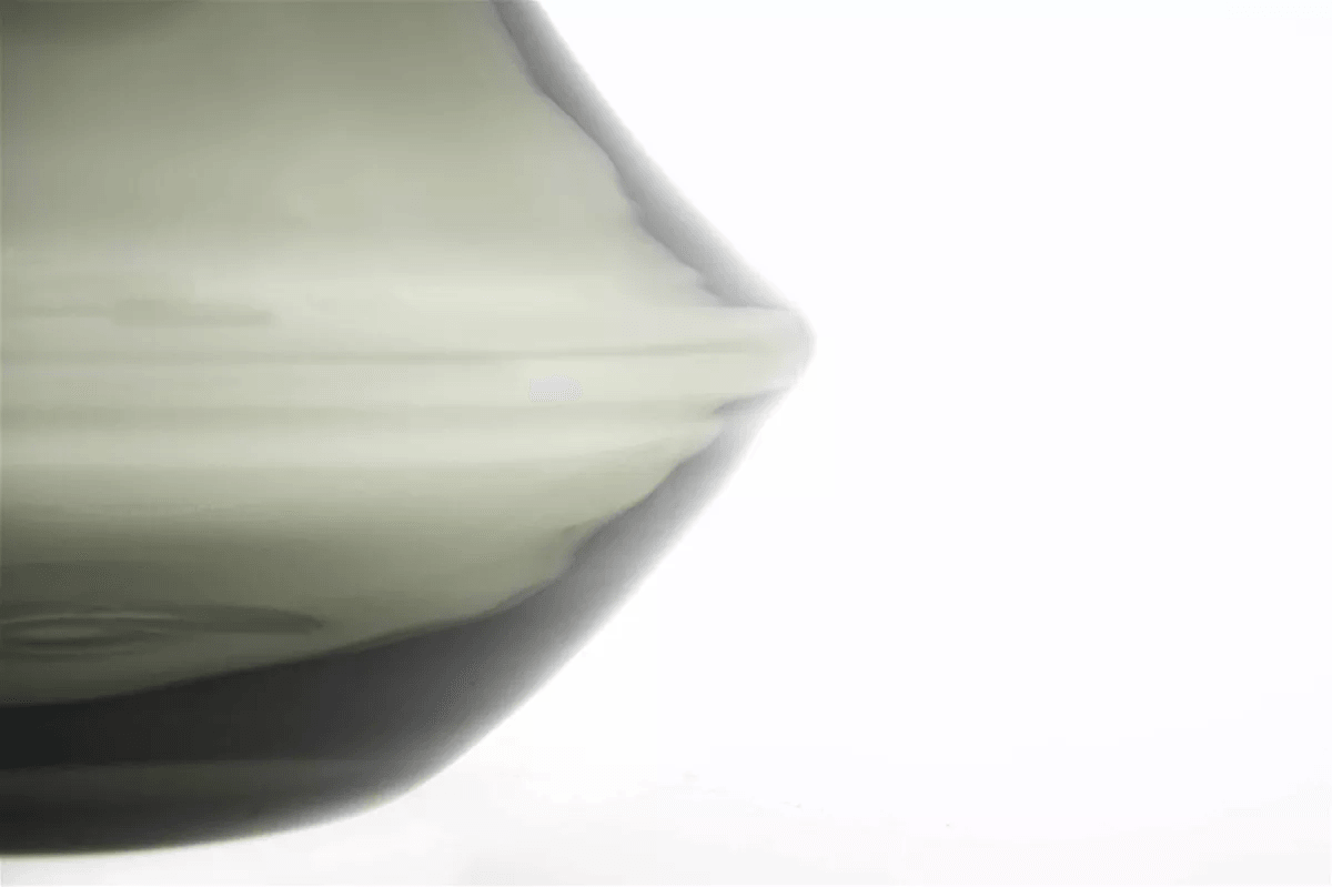 Close-up of Lowlands Design vase glass with smooth translucent surface and curved shape