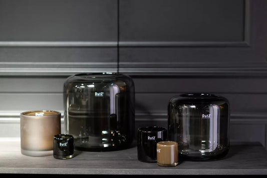 Lowlands Design glass vase collection in various sizes and shades displayed on grey wooden surface