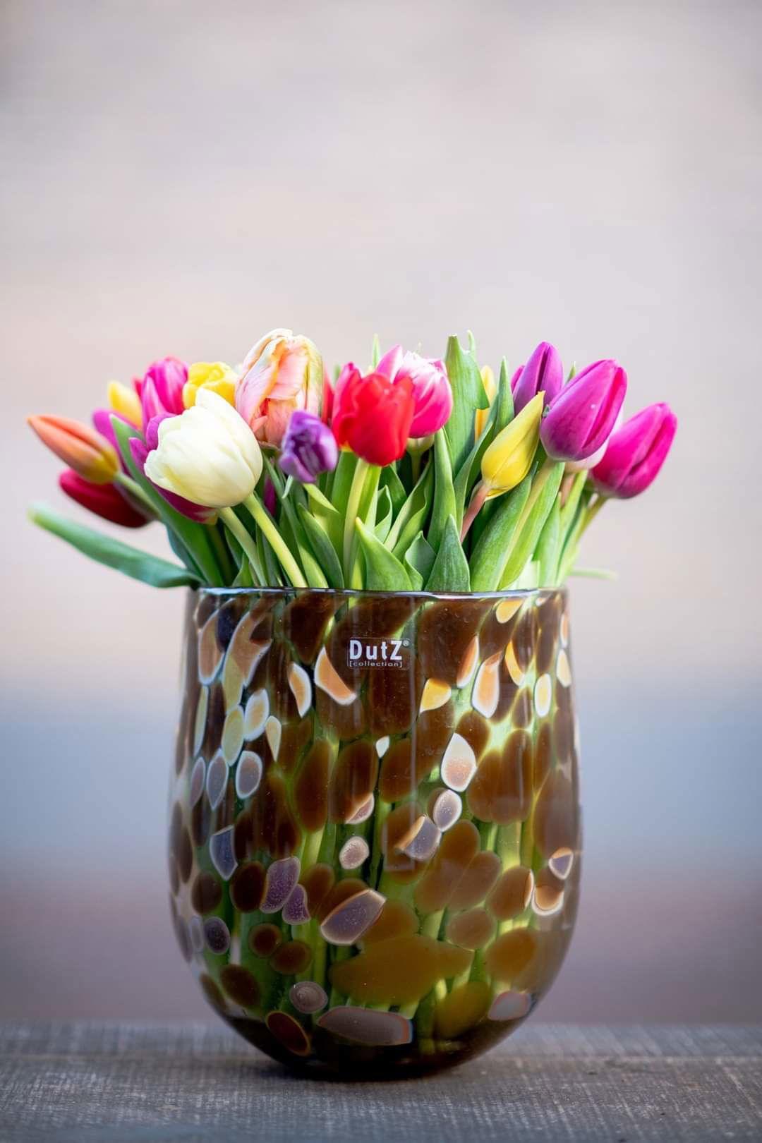 Lowlands Design barrel vase with multi-colored spotted glass holding vibrant tulips