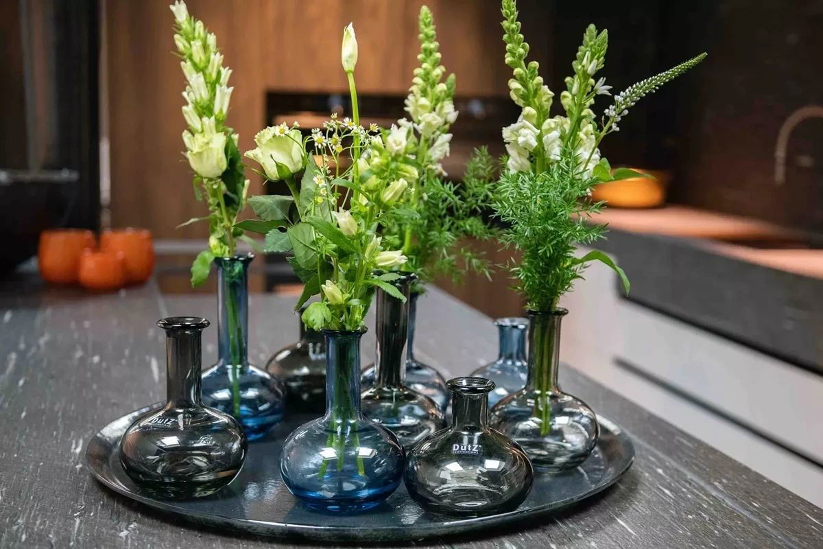 Lowlands Design glass vase set with green floral arrangements on a black tray for home decor