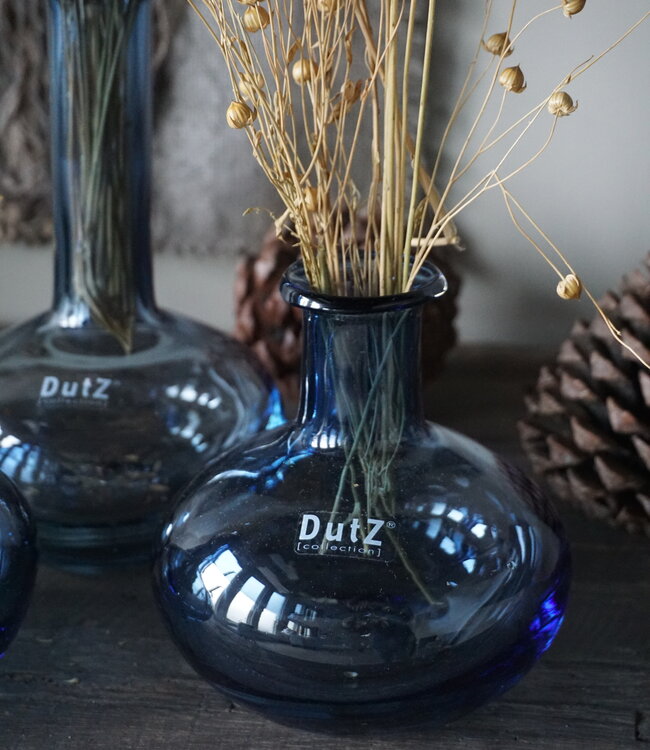 Lowlands Design blue glass vase set with rounded base and dried floral arrangement inside