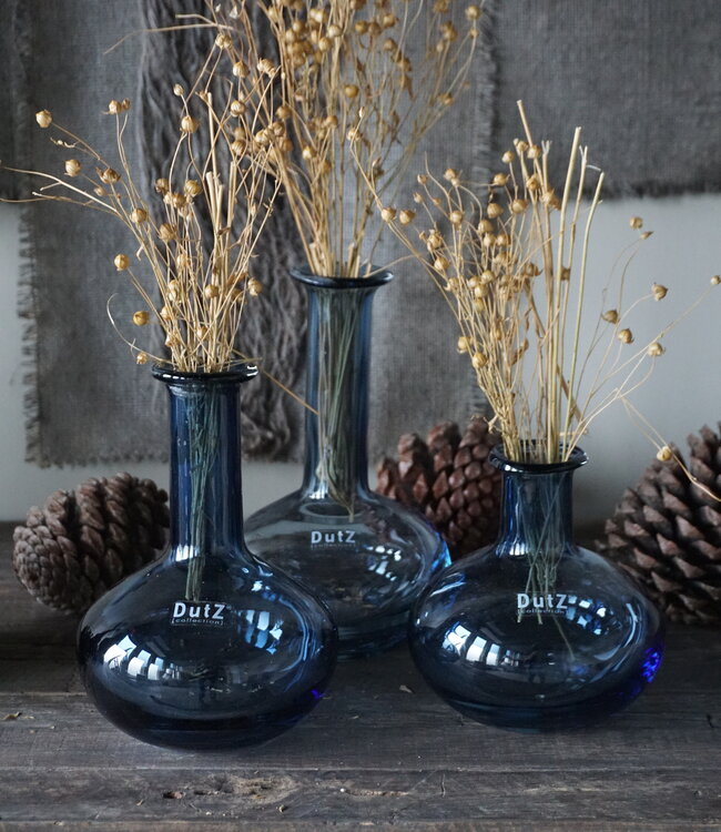 Lowlands Design blue glass vase set with dried flowers and pinecones on rustic wooden surface