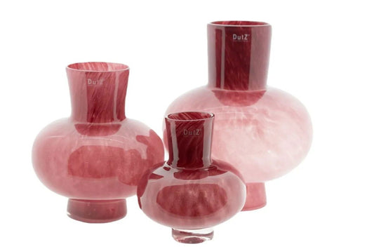 Set of three decorative red glass vases by Lowlands Design with unique rounded shapes