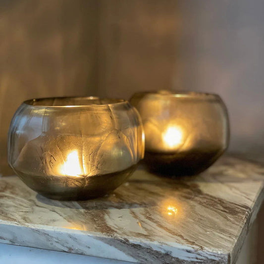 Lowlands Design glass candleholder set with warm glowing candles on marble surface