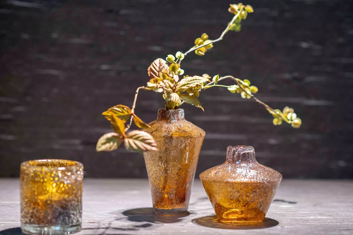Lowlands Design amber glass vase diffuser with textured surface and decorative foliage