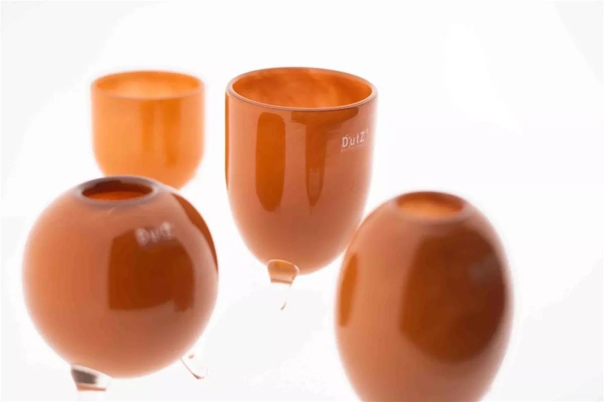 Lowlands Design vase set glass feet in amber orange with modern rounded shapes and clear glass bases