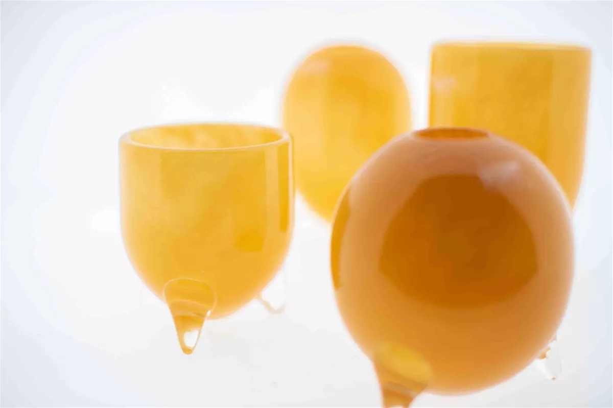 Lowlands Design amber coloured vase set glass feet with unique rounded and tubular shapes