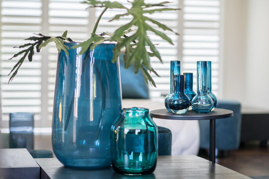 Blue glass vases and bowls in various shapes and sizes enhancing modern interior design