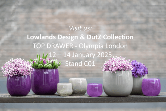 DutZ Collection of purple and grey glass vases with flowers promoting top drawer trade fair at Olympia London
