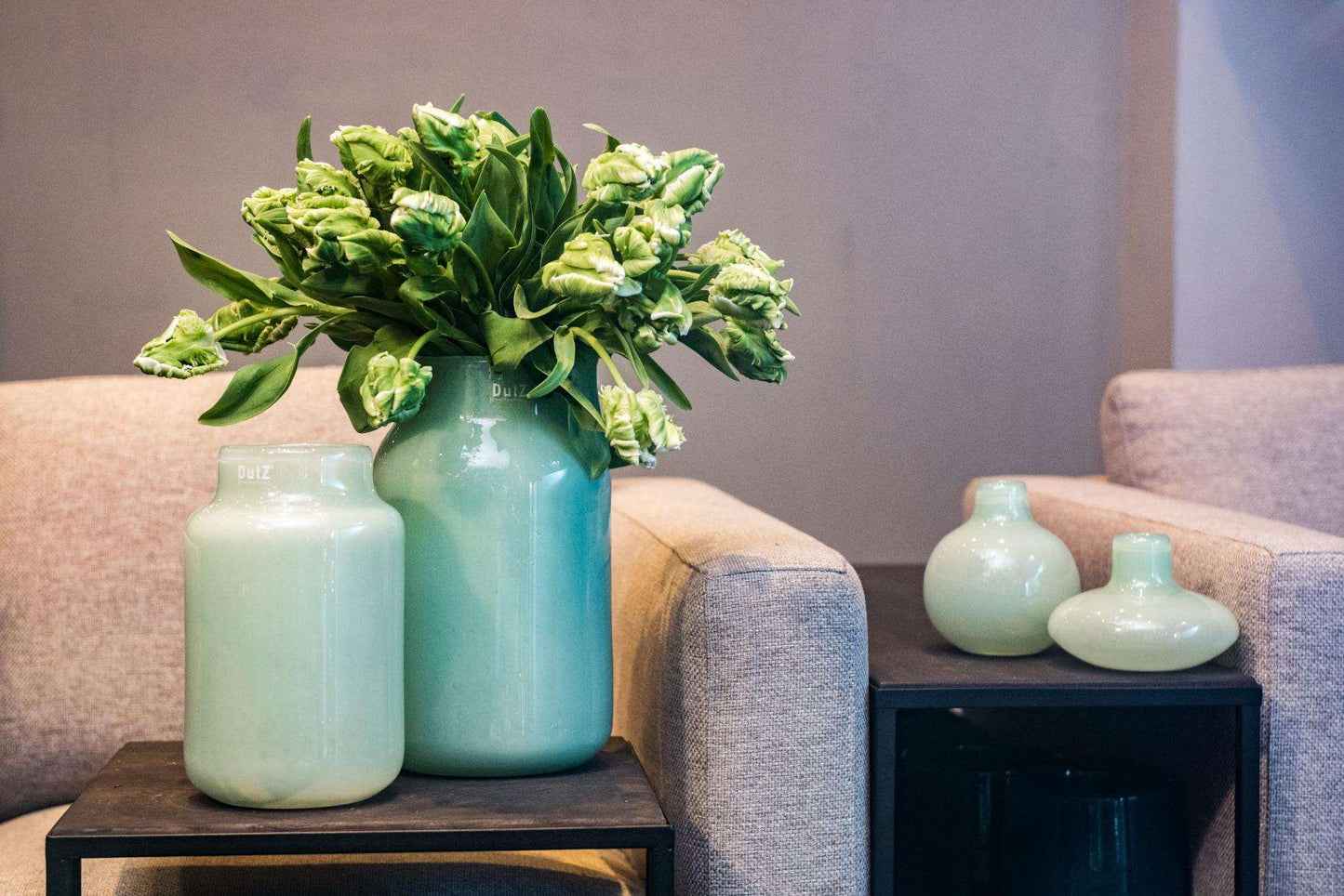 Lowlands Design Apothecary Glass Vase in mint green with fresh flowers, placed on modern furniture