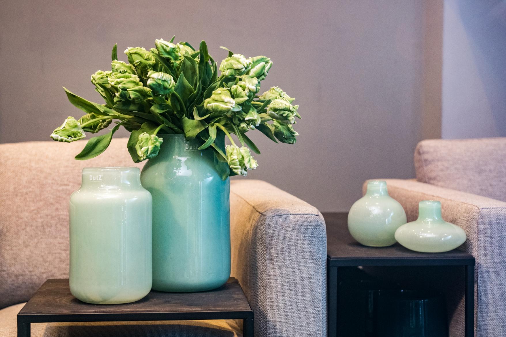 Lowlands Design Apothecary Glass Vase in mint green with fresh flowers, placed on modern furniture