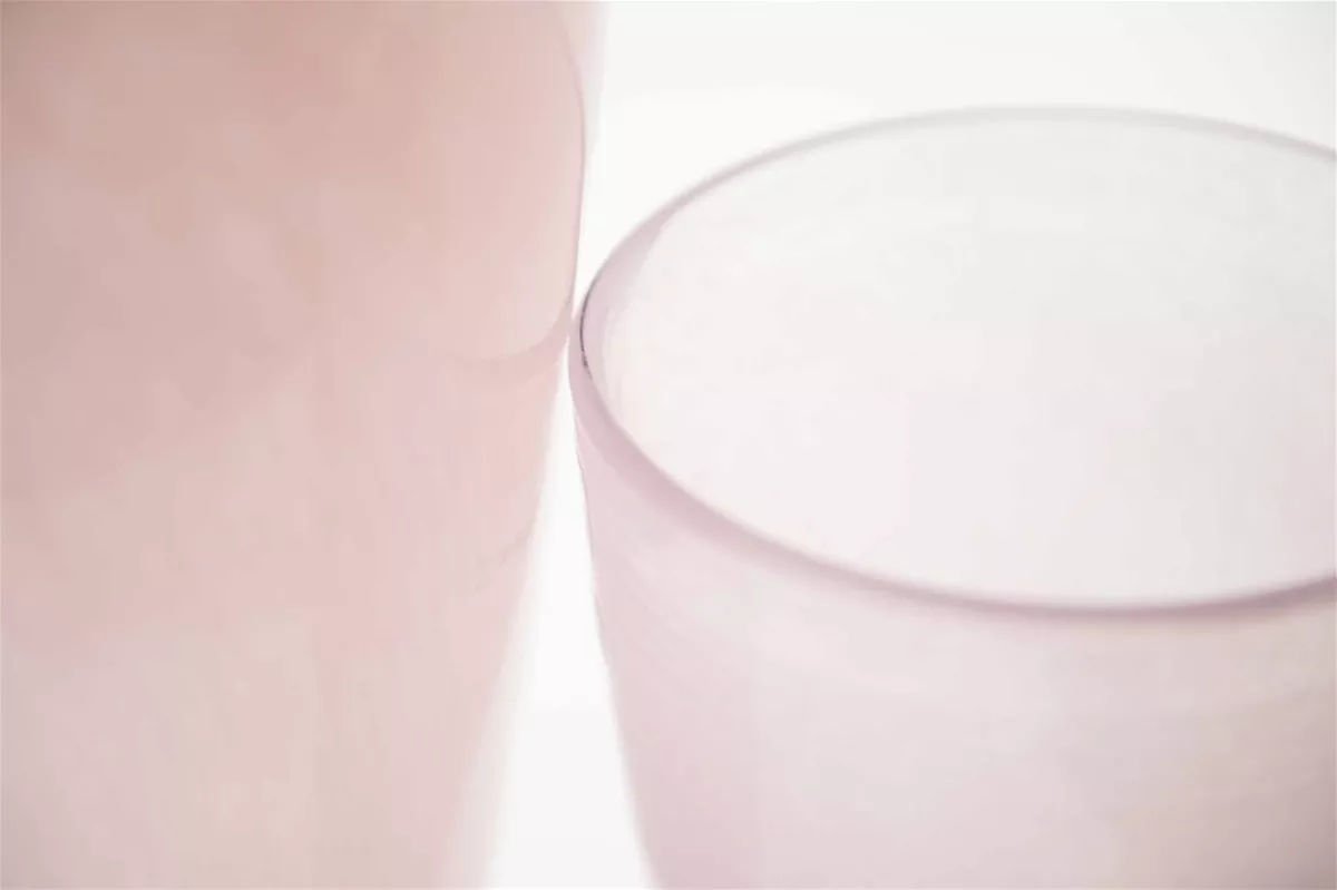 Close-up of pink frosted glass flower vase by Lowlands Design with smooth curved edges