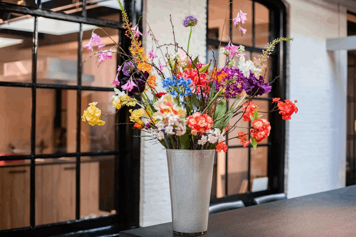 Stylish Lowlands Design flowervase glass mouthblown filled with vibrant flowers in a modern setting