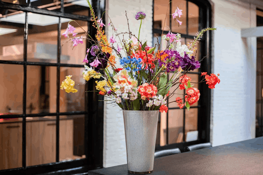 Stylish Lowlands Design flowervase glass mouthblown filled with vibrant flowers in a modern setting
