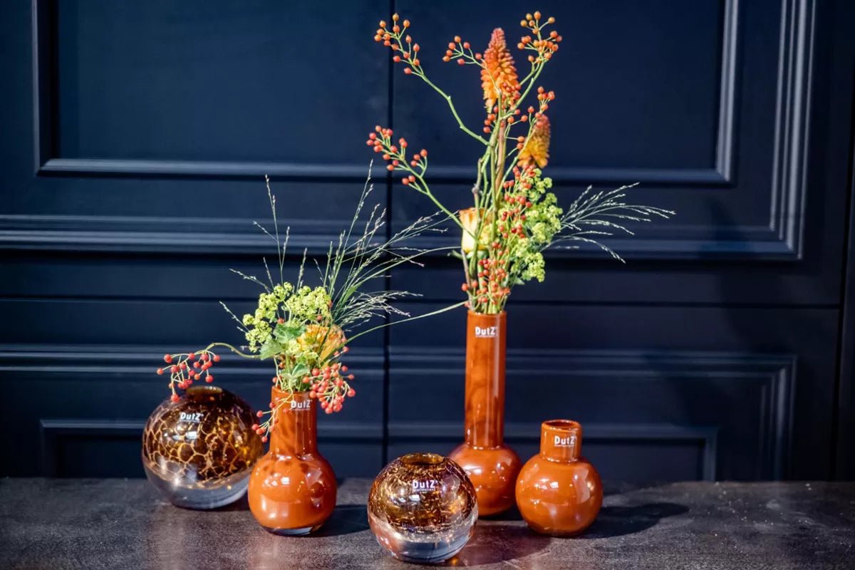 Lowlands Design ball vase collection featuring glossy round and tall vases with floral arrangements