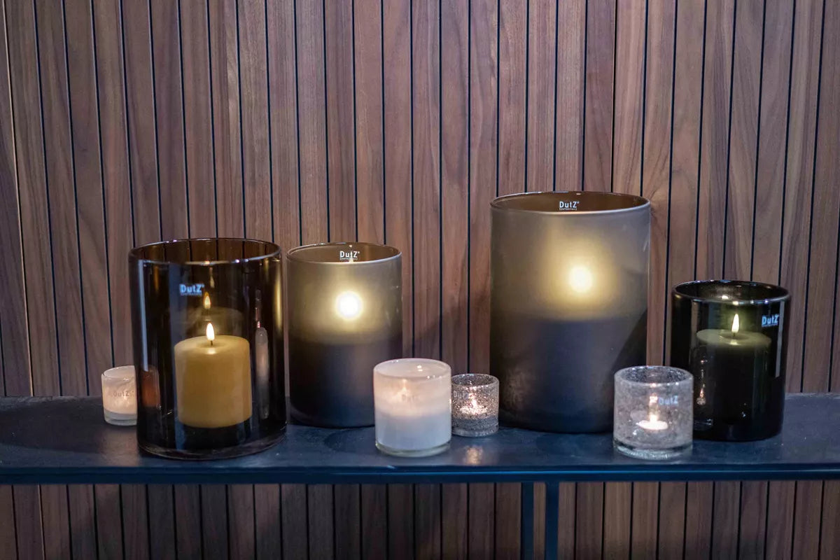 Lowlands Design glass cylinder candlholder smoke arranged with lit candles on a wooden shelf