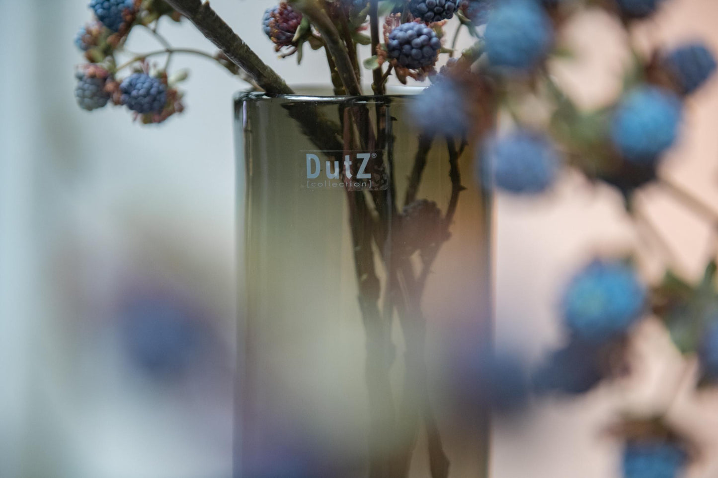 Stylish glass cylinder vase from Lowlands Design with floral arrangement in a muted colour